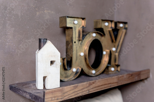 small wooden house new home concept.Text Message wording of the word JOY in my new house. Let dreams come true.card, invitation to housewarming.Enjoy.Trendy home decoration,nightlight, night lamp.Copy photo