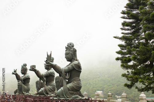 Photography three of Six Devas Buddhistic statue praise, make offering to Tian Tan big Buddha near Po Lin Monastery Hong Kong