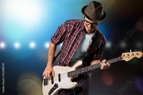 Man playing guitar on light background