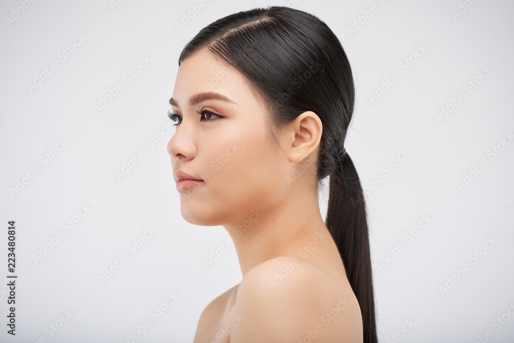 Attractive young Vietnamese woman, isolated on light grey Attractive young Vietnamese woman, isolated on light grey