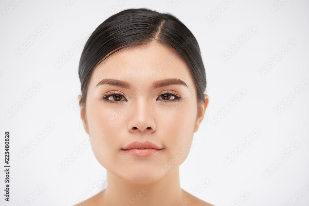 Face of attractive young Asian woman with natural make-up looking at camera Face of attractive young Asian woman with natural make-up looking at camera