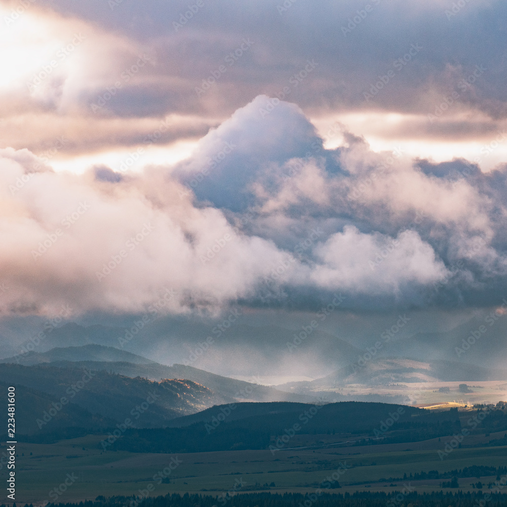Beautiful landscape, with sun rays through the clouds over mountain landscape.