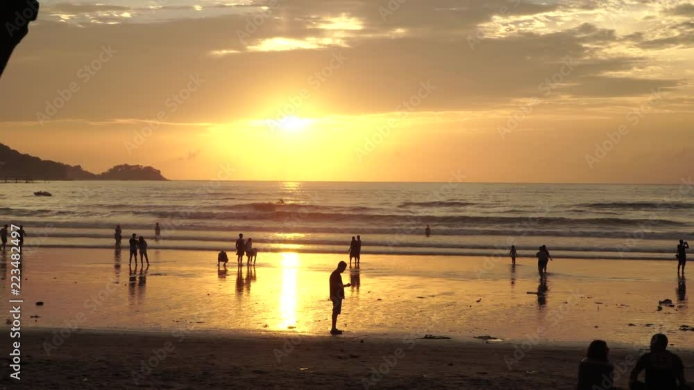 silhouette people at sunset on tropical beach silhouette people at sunset on tropical beach