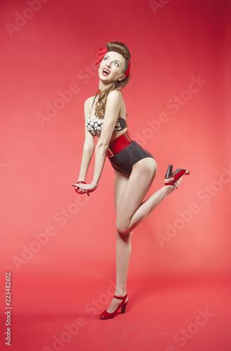 portrait of girl in pin up style on red background

