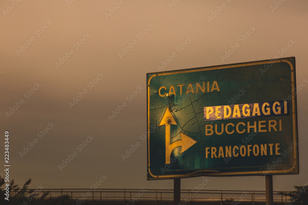 Road sign indicates the way to Catania, Italy 