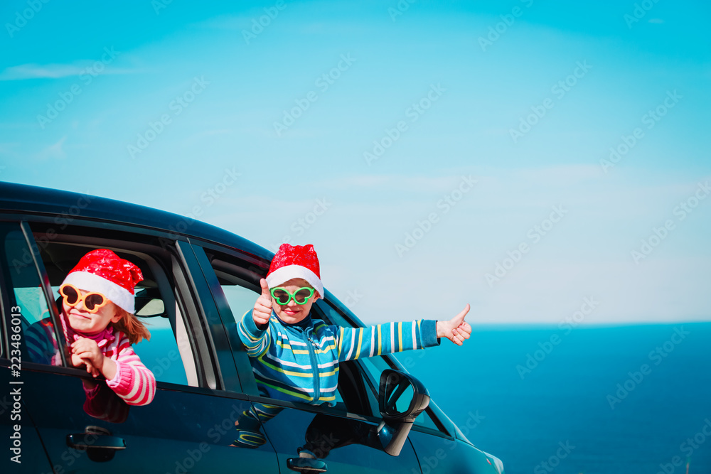 christmas car travel- happy kids travel in winter at sea