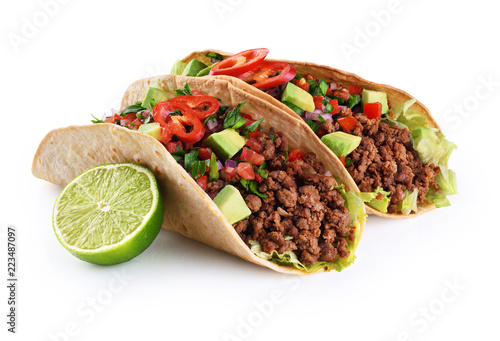 Mexican tacos with beef, tomatoes, avocado, chilli and onions isolated on white background.