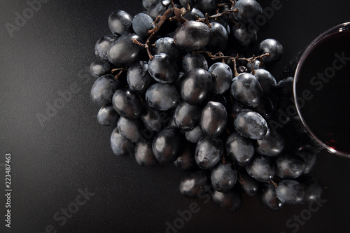 Black grapes and a glass of wine.