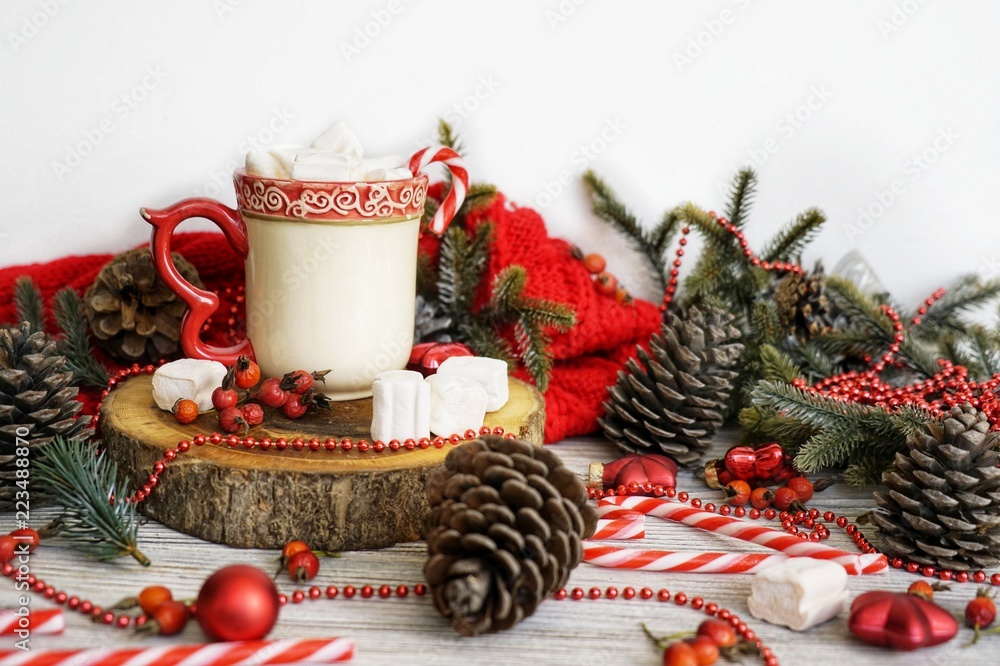 A cup of hot winter drink with marshmallow and cinnamon. New Year's background. A cup of hot winter drink with marshmallow and cinnamon. New Year's background.