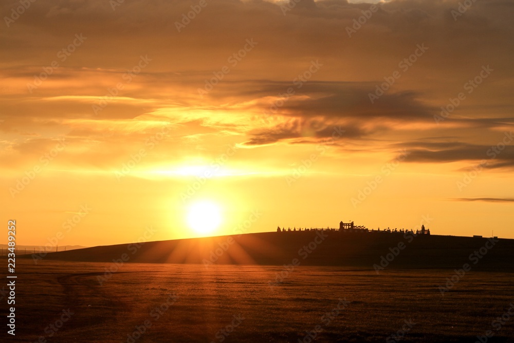 Fototapeta premium Mongolian sunrise over horse monument