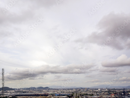 Aerial view of logistics concept commercial vehicles, cars and pickup trucks waiting to be load on to a roll-on/roll-off car carrier ship at Laem Chabang dockyard in Chonburi Province, Thailand