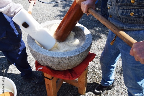 How to make Japanese traditional rice cakes(Mochi-tsuki)is many times pounding with a mallet with the steamed dlutinous rice which was in mortar. photo