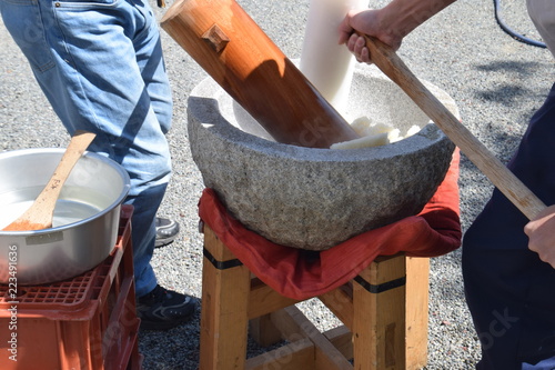 Photography How to make Japanese traditional rice cakes(Mochi-tsuki)is many times pounding with a mallet with the steamed dlutinous rice which was in mortar