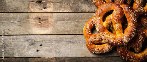 Fotografie, Obraz Oktoberfest concept - pretzels on rustic wood background, top view