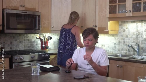 A young diabetic patient, 12 years old, at home testing his blood sugar.