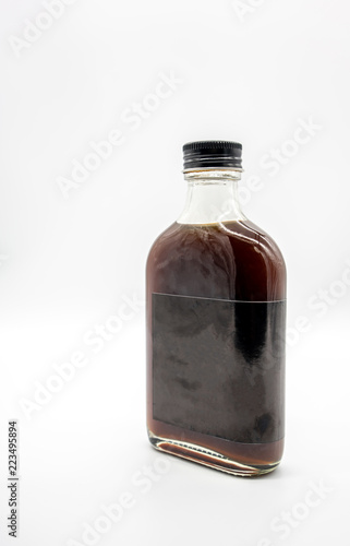 Cold Brew Coffee in glass bottle with black cap isolated on white