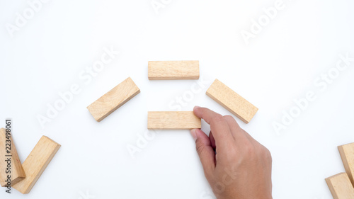wooden block with hand on white background copy space