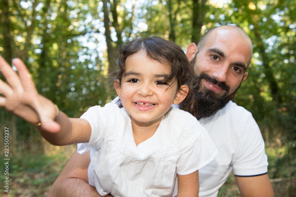 playfull daughter child with bald man father outdoor home garden playfull daughter child with bald man father outdoor home garden