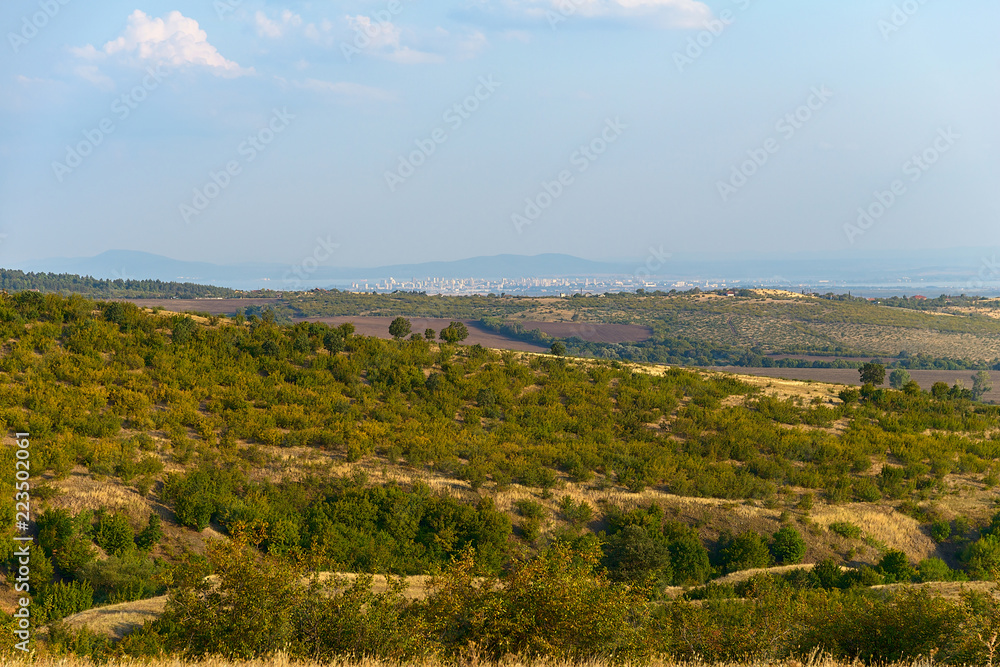 The top view on the valley among the Old Balkan Mountains. In the background are the Burgas Bay and the city of Burgas. Bulgaria.