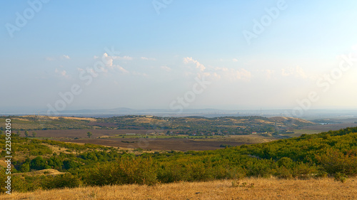 The top view on the valley among the Old Balkan Mountains. In the background, Burgas Lake and an oil refinery. Bulgaria.