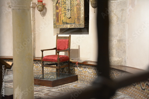 old Red empty chair in a church in Italy