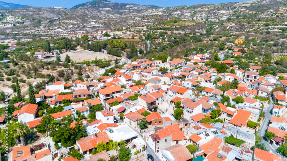Aerial Lania (Laneia) wine village, Limassol, Cyprus. Bird's eye view of traditional Mediterranean, picturesque alleys, red ceramic roof tile houses, vineyards, church and entrance. 