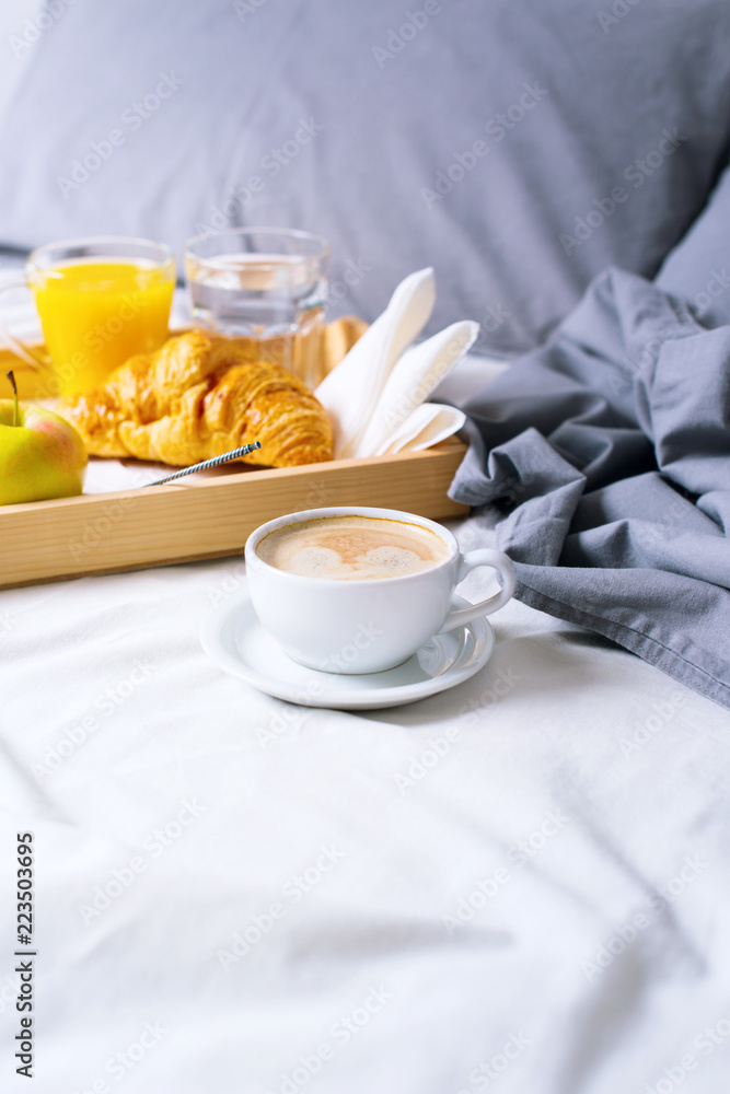 morning breakfast bed wooden tray coffee croissant