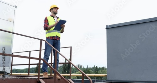 Wallpaper Mural architect in helmet and safety vest making notes in notepad Torontodigital.ca