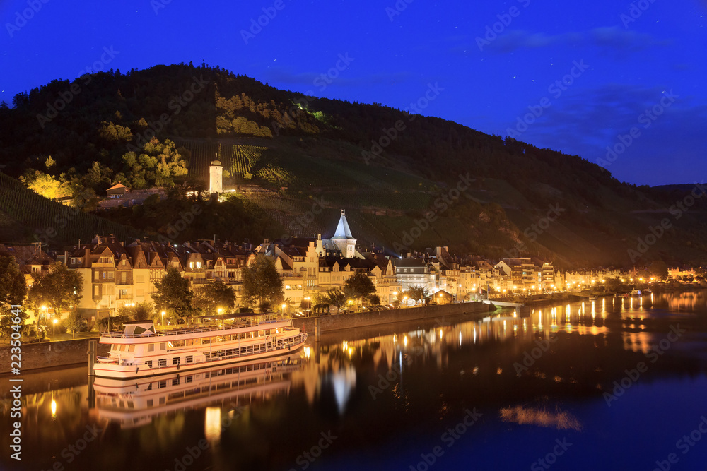 Beautiful small wine growing town Zell (an der Mosel) at the river Moselle in Germany at night, a popular tourist cruise destination
