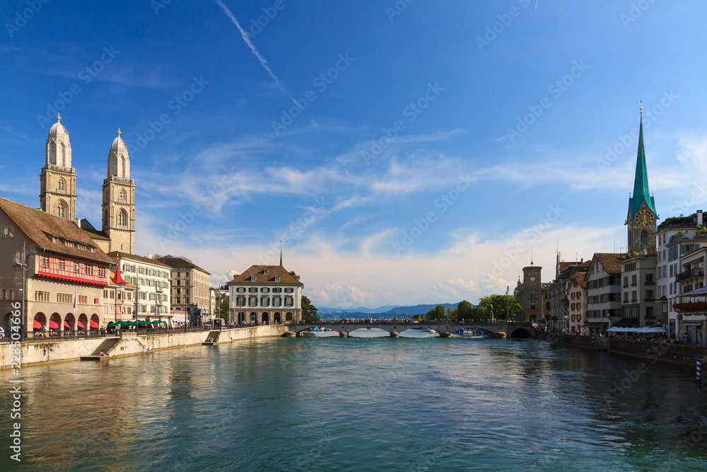 Beautiful summer cityscape of the city Zurich, Switzerland, at the river Limmat and the Grossmünster and Fraumünster churches
