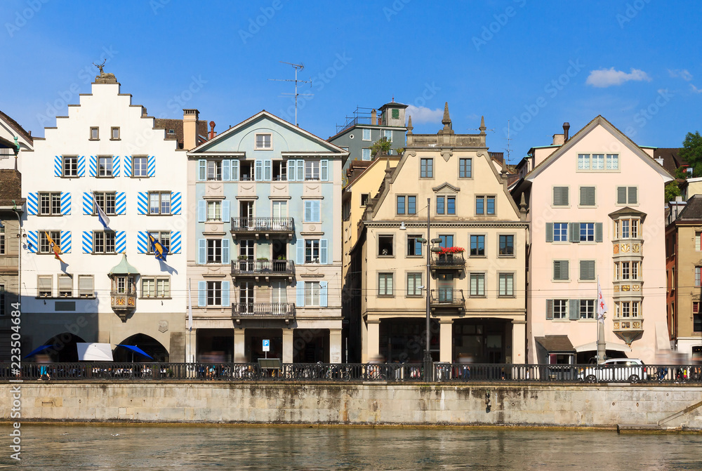 Beautiful cityscape of Zurich, Switzerland, with traditional houses, seen from the shore of the river Limmat in summer
