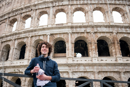 Handsome young guy relaxing after training in front of Colosseum in Rome © Marko Rupena