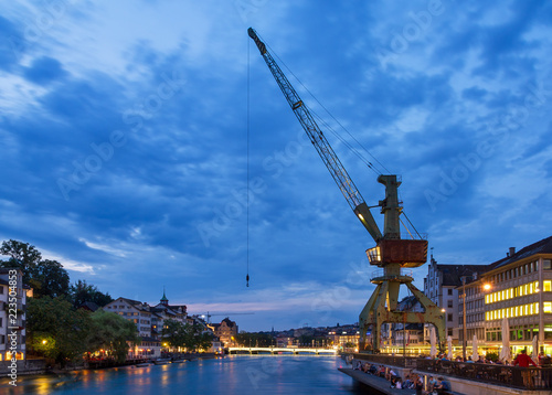 Beautiful cityscape of Zurich, Switzerland, with the crane at the river Limmat during the blue hour at night