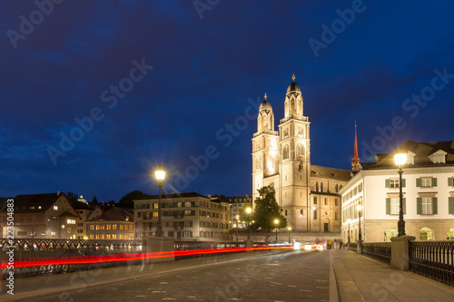 Beautiful cityscape of Zurich  Switzerland  with the Grossm  nster Protestant church  seen from the bridge over the river Limmat at night in summer