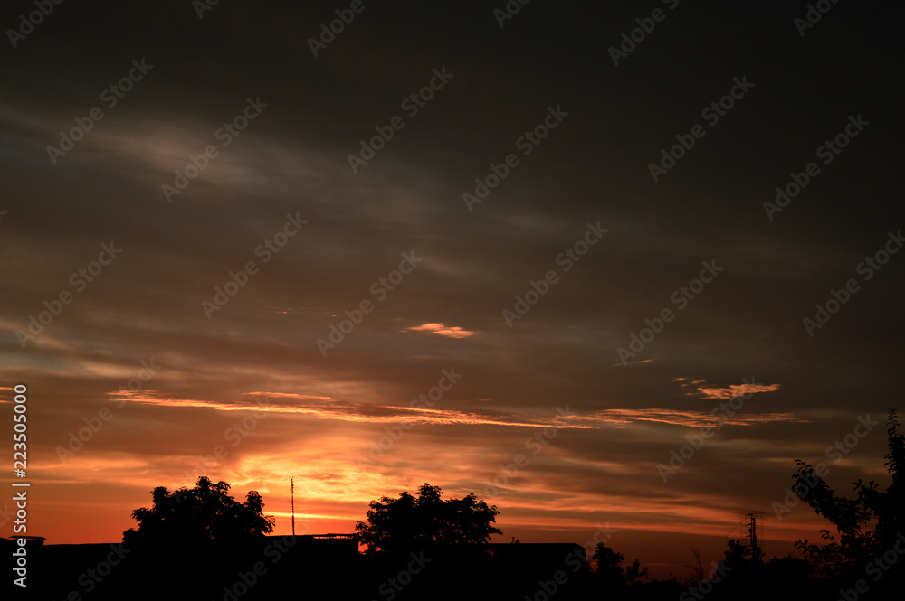 Fototapeta premium Evening red sunset breaks through the clouds.