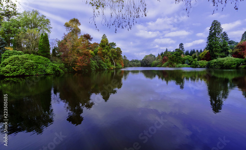 English autumn with Sheffield lake, trees and visible sun rays in Uckfield, East Sussex, United Kingdom