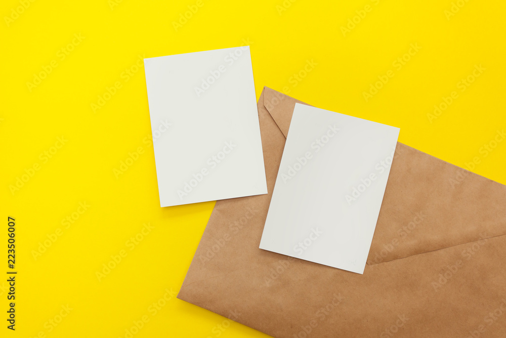 two blank postcard with brown envelope on yellow background two blank postcard with brown envelope on yellow background