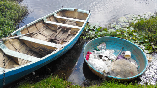 Boat in water with waste, plastics garbage