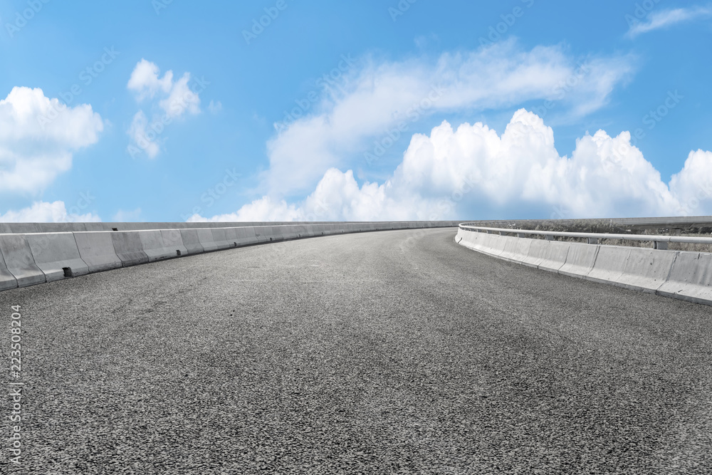 Road pavement under blue sky and white clouds