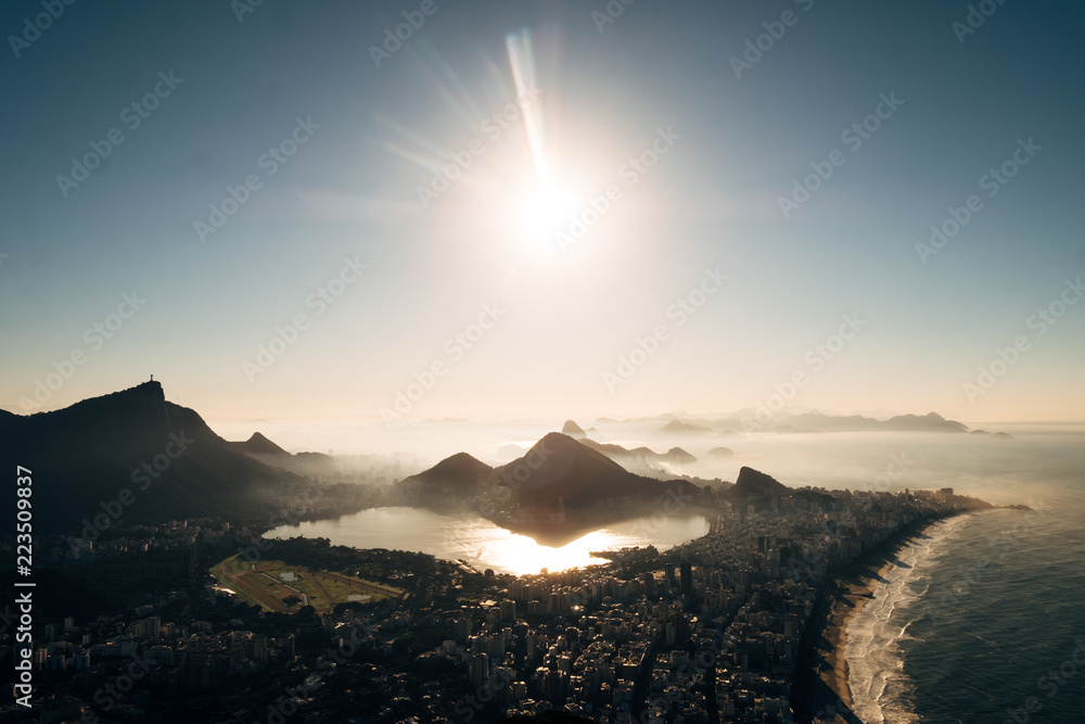 Brazil, Rio de Janeiro. Meeting the dawn on the hill Two brothers. View of the big city, lake, ocean, hills, mountains. Orange-blue colors