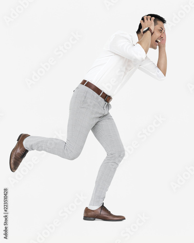 Stressed businessman running away from a crisis