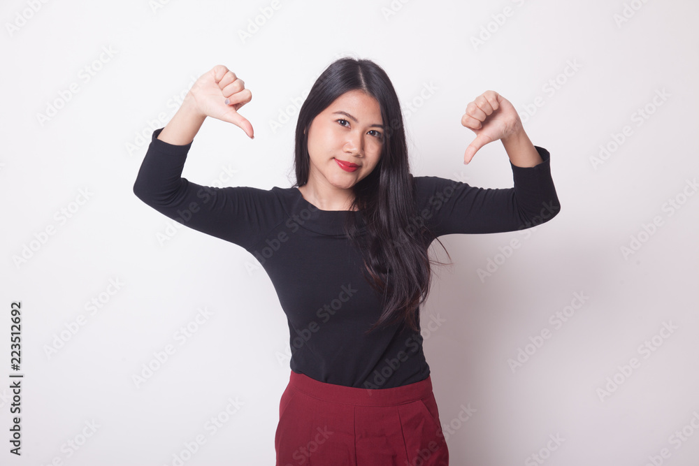 Unhappy Asian girl show thumbs down with both hands. Unhappy Asian girl show thumbs down with both hands.
