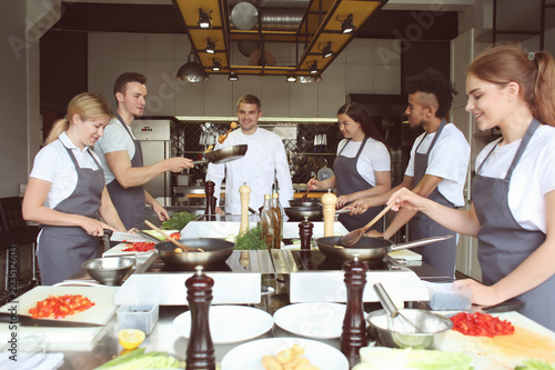 Chef and group of young people during cooking classes photo