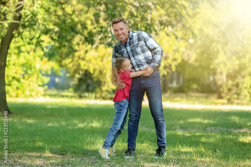 Happy father and daughter in green park