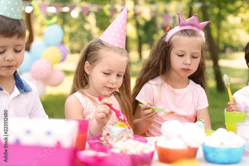 Cute children celebrating birthday outdoors