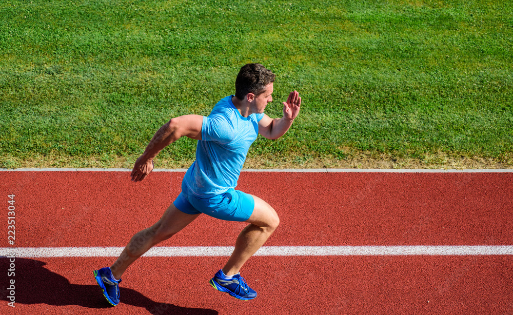 Athlete run stadium green grass background. Life non stop motion. Runner  sporty shape in motion. Sport lifestyle and health concept. Man athlete run  to achieve great result. Impulse to move Photos