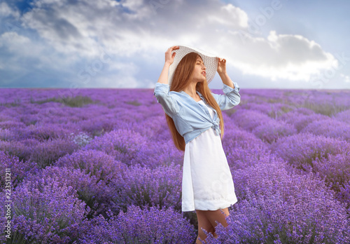 Fototapeta Naklejka Na Ścianę i Meble -  Beautiful young woman in lavender field on summer day