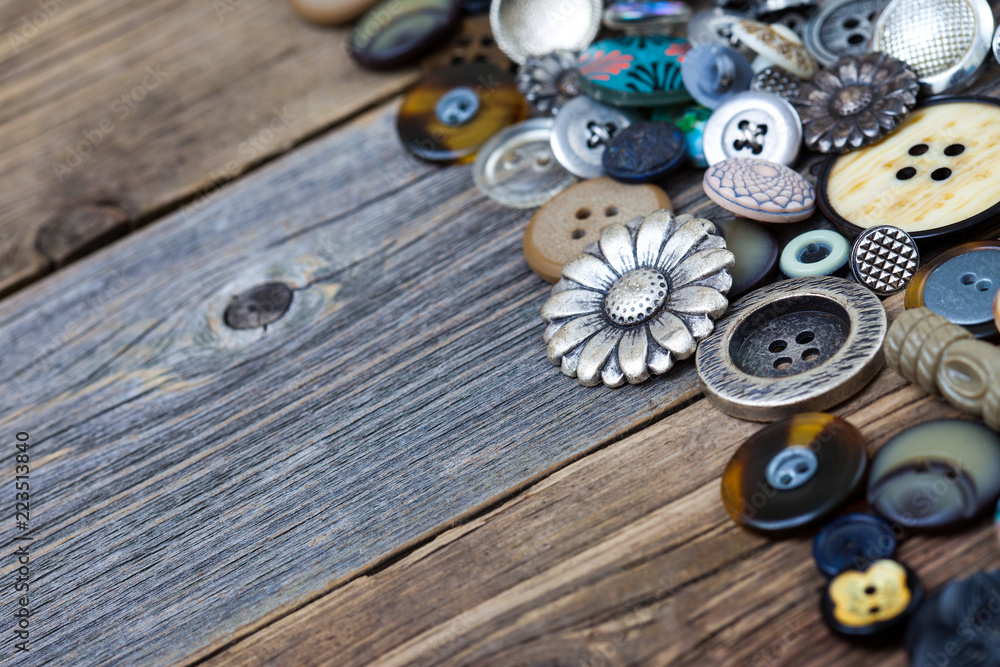 buttons in large numbers scattered on aged wooden boards buttons in large numbers scattered on aged wooden boards