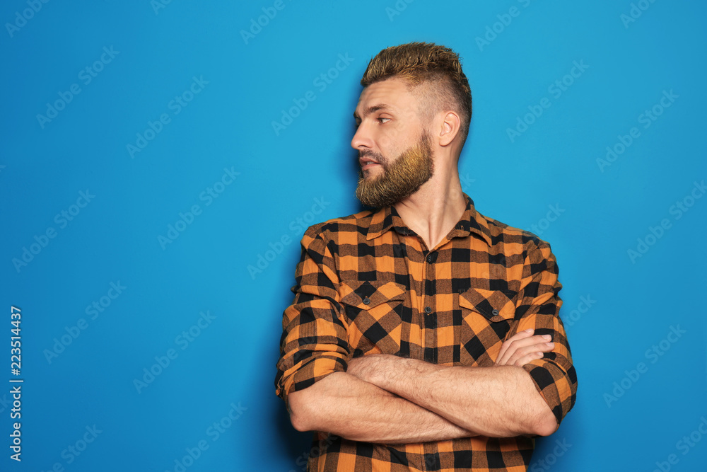 Portrait of handsome man with dyed hair and beard on color background Portrait of handsome man with dyed hair and beard on color background