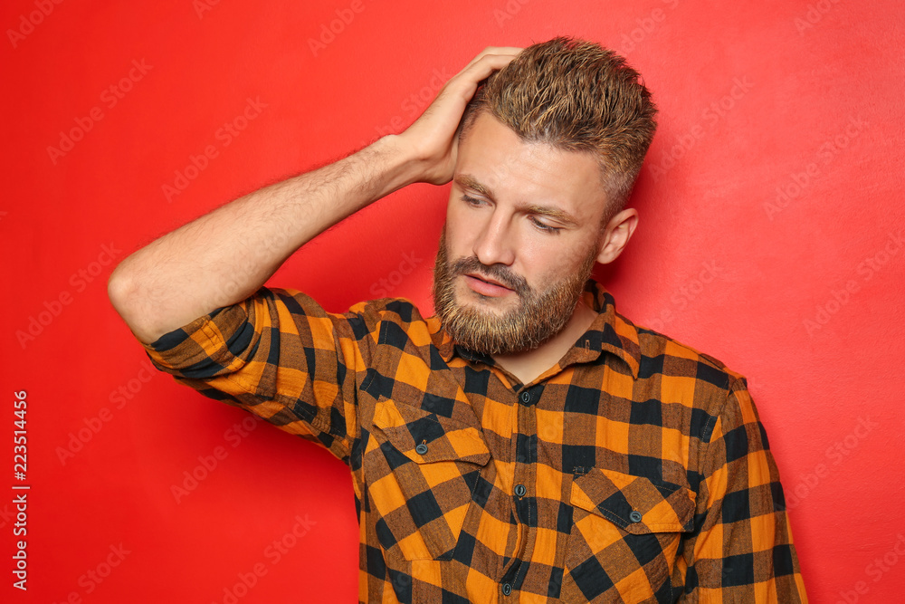 Portrait of handsome man with dyed hair and beard on color background Portrait of handsome man with dyed hair and beard on color background